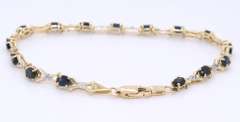 Fantastic Yellow Gold Oval Blue Sapphire and Diamond X Bracelet