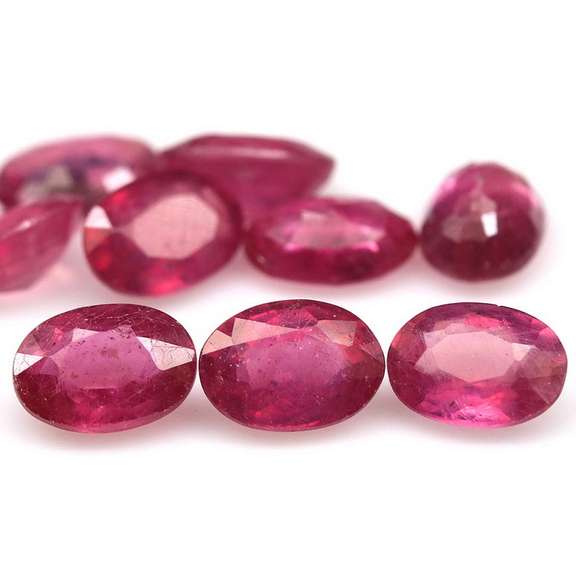 Vibrant 9.33ct oval cut reddish pink Ruby set