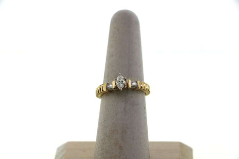 Brilliant Oval Diamond Ring flanked by Baguette Diamonds on a 14k Gold Band