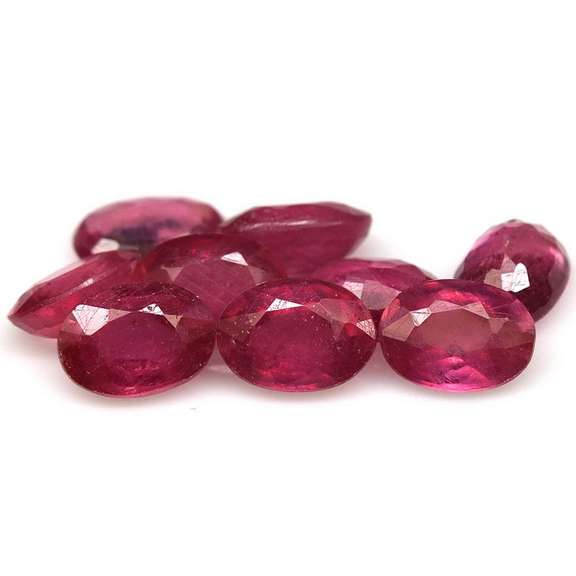 Vibrant 9.33ct oval cut reddish pink Ruby set