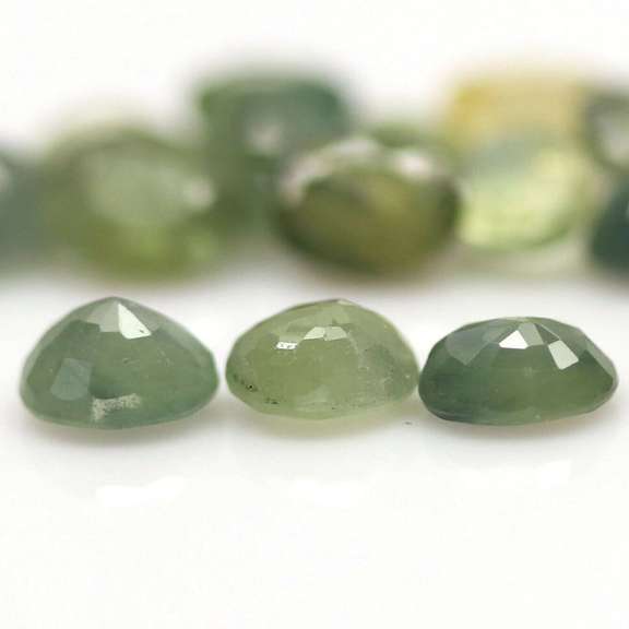 Heated only! 8.29ct oval cut green Sapphire set