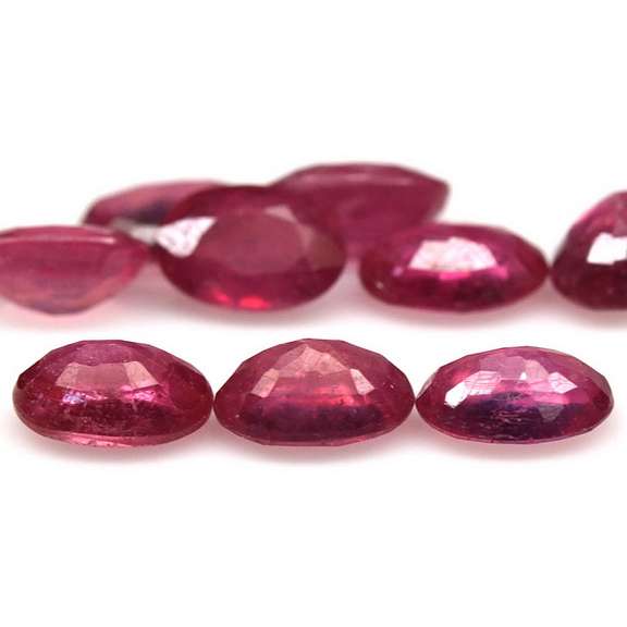 Vibrant 9.33ct oval cut reddish pink Ruby set
