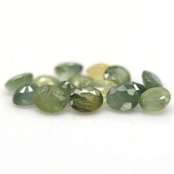 Heated only! 8.29ct oval cut green Sapphire set