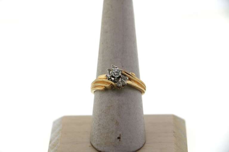Graceful Centerpiece Round Diamond Ring encircled by stepped Diamonds on a 14k Gold Band