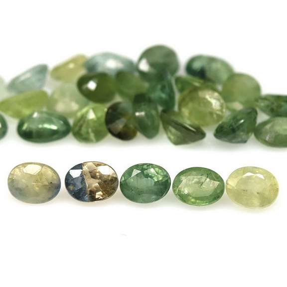 Heated only! 7.42ct oval cut green Sapphire set
