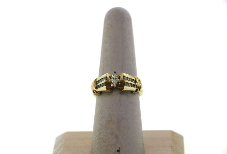 Geometric Oval Diamond Ring flanked by Channel Set Diamonds on a 14k Gold Band