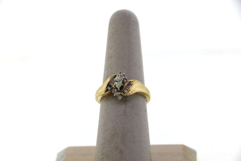 Exquisite Oval Diamond Ring surrounded by Baguette and Round Diamonds on a 14k Gold Band