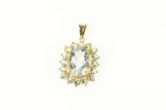 14K Yellow Gold Oval Syn. Blue Topaz Halo Statement Pendant