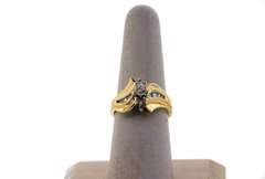 Gorgeous Centerpiece Diamond Ring flanked by Round Diamonds and Baguette Diamonds with 14k Gold