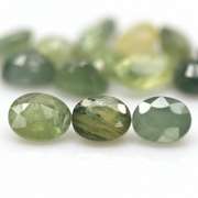Heated only! 8.29ct oval cut green Sapphire set