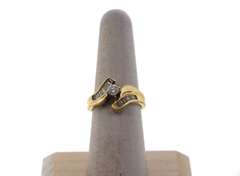 Beautiful Round Diamond Centerpiece Ring clasped by a 14k Gold band with Baguette Diamonds