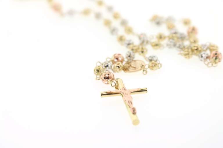 Attractive 14kt gold beaded rosary with cross pendant