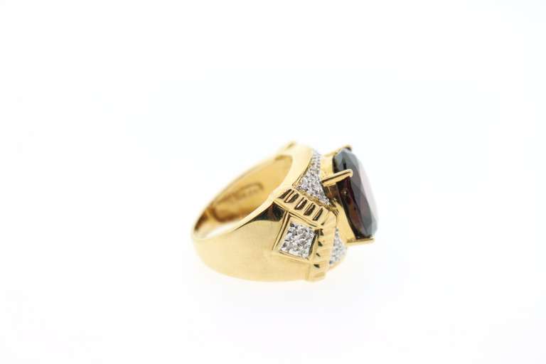 14K YELLOW GOLD GARNET & DIAMOND RING.