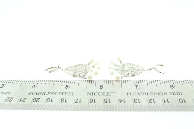 6MM CULTURED PEARL AND DIAMOND CHANDELIER EARRINGS.