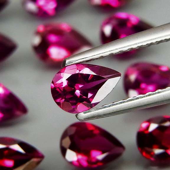 Premium pear cut 9.49ct VS Rhodolite Garnet set