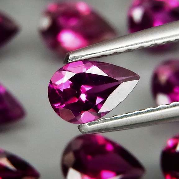 Premium pear cut 9.22ct VS Rhodolite Garnet set