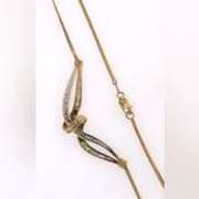 14k yellow gold necklace with two tone gold wrap around diamond pendant