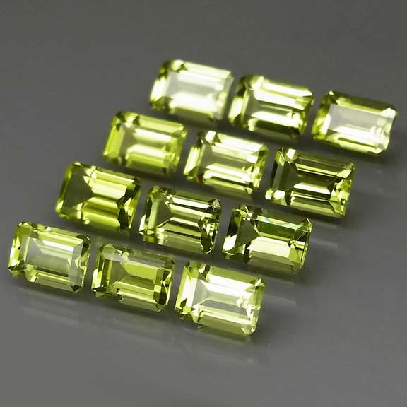 Brilliant 7.62ct 12pc set of matched emerald cut Peridot