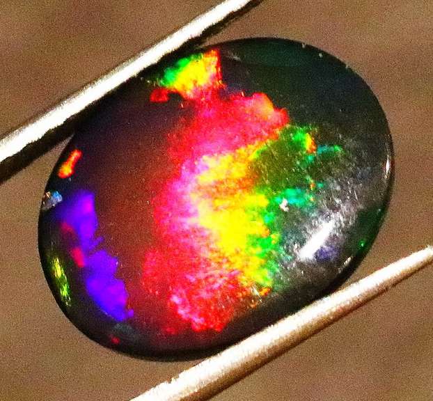 Striking 2.39ct full body and full spectrum flashing Black Opal