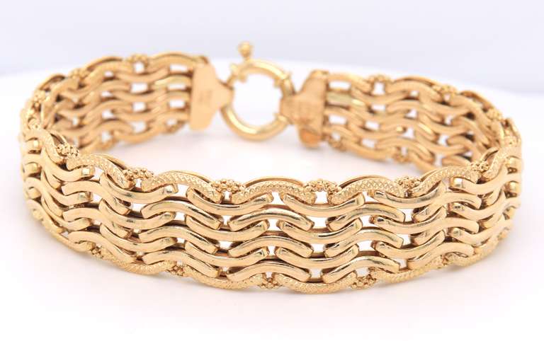 Handsome Yellow Gold High Polished and Textured Wave Wide Bracelet