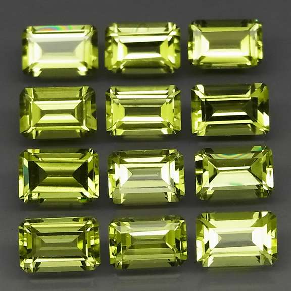 Brilliant 7.62ct 12pc set of matched emerald cut Peridot