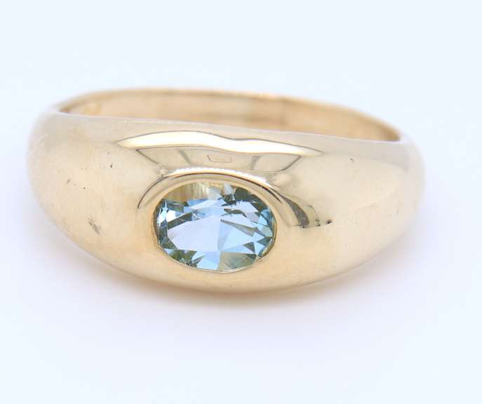 Handsome Yellow Gold oval Blue Topaz Bezel Set Ring