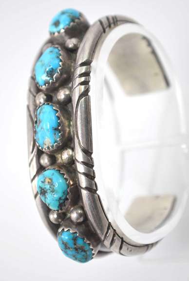 5 Turquoise Stones Set In A Thick Sterling Silver Bracelet.