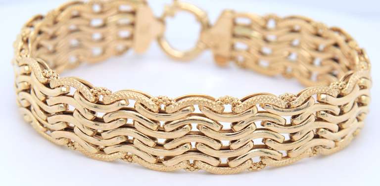 Handsome Yellow Gold High Polished and Textured Wave Wide Bracelet