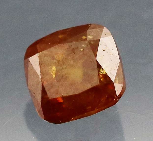 Stunning .28ct cushion cut red orange Diamond