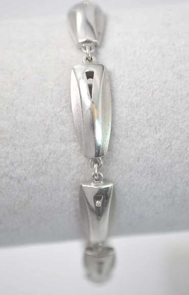 Stylish Sterling Silver Bracelet With CZ Stones And Alternating Matte And Polished Texture.