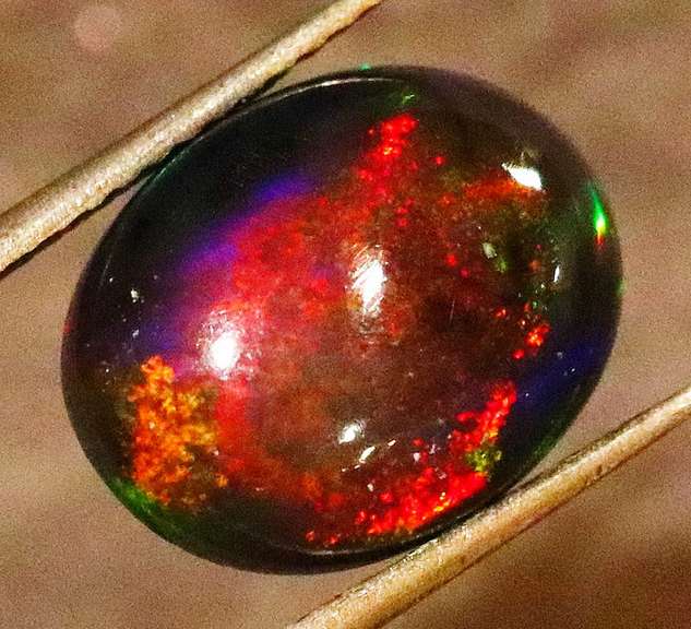Striking 2.39ct full body and full spectrum flashing Black Opal
