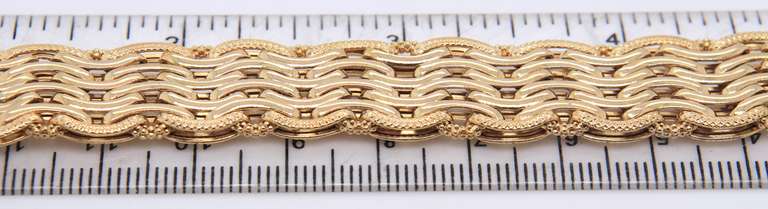 Handsome Yellow Gold High Polished and Textured Wave Wide Bracelet
