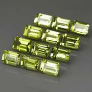 Brilliant 7.62ct 12pc set of matched emerald cut Peridot
