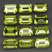 Brilliant 7.62ct 12pc set of matched emerald cut Peridot