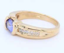 Attractive Yellow Gold oval Tanzanite and Side Channel Set Diamond Ring