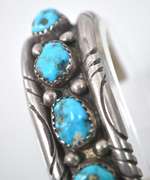 5 Turquoise Stones Set In A Thick Sterling Silver Bracelet.