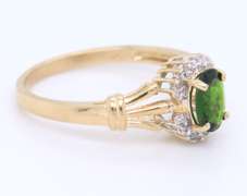 Charming Yellow Gold oval Peridot and Diamond Halo Ring