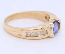 Attractive Yellow Gold oval Tanzanite and Side Channel Set Diamond Ring