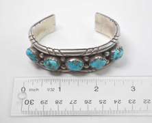 5 Turquoise Stones Set In A Thick Sterling Silver Bracelet.
