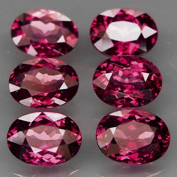 Amazing 9.27ct oval cut violet red Garnet set