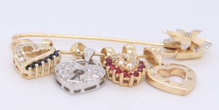 Attractive Yellow Gold Safety Pin with 4 Charms