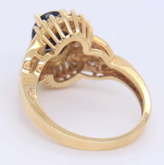 Attractive Yellow Gold oval Blue Sapphire and Baguette Diamond Ring