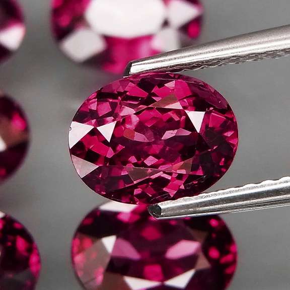 Amazing 9.27ct oval cut violet red Garnet set
