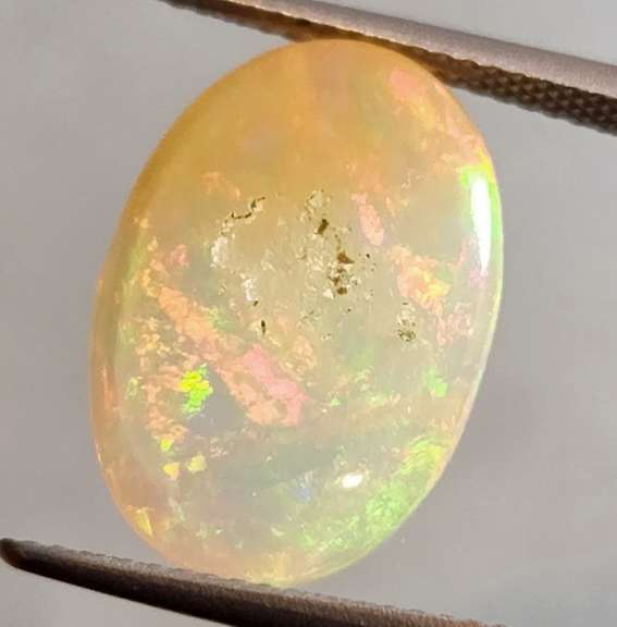 Full cover! 8.08ct rolling floral flashing Welo Opal