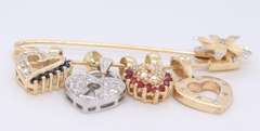 Attractive Yellow Gold Safety Pin with 4 Charms