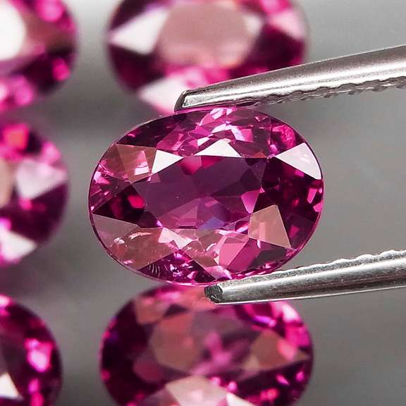 Excellent 8.81ct oval cut violet red Garnet set