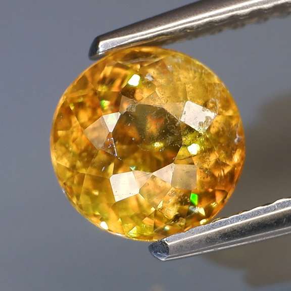 1.50ct rich golden Sphene with rainbow sparks