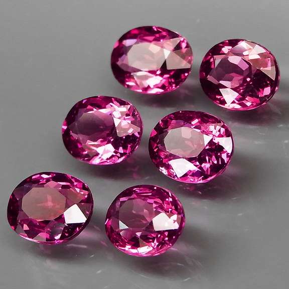Excellent 8.81ct oval cut violet red Garnet set