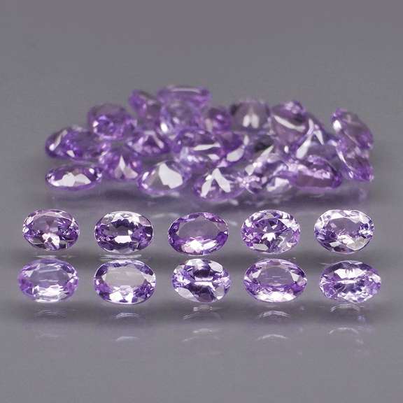 Heavy flashing 5.47ct oval cut Tanzanite set