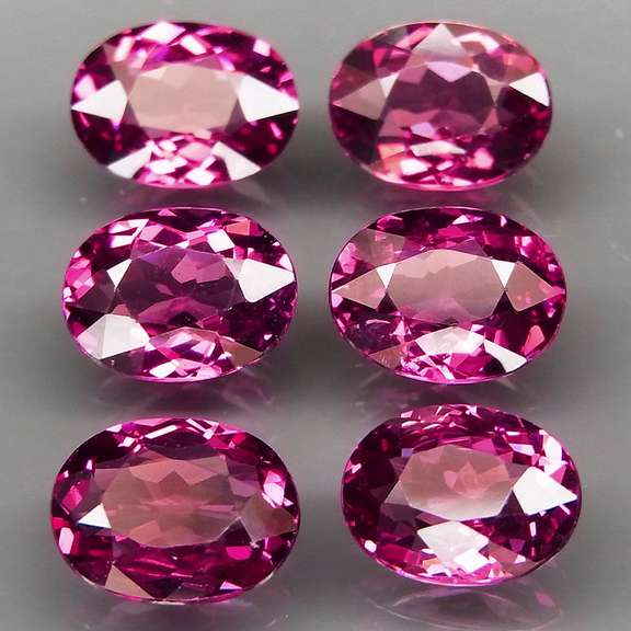 Excellent 8.81ct oval cut violet red Garnet set